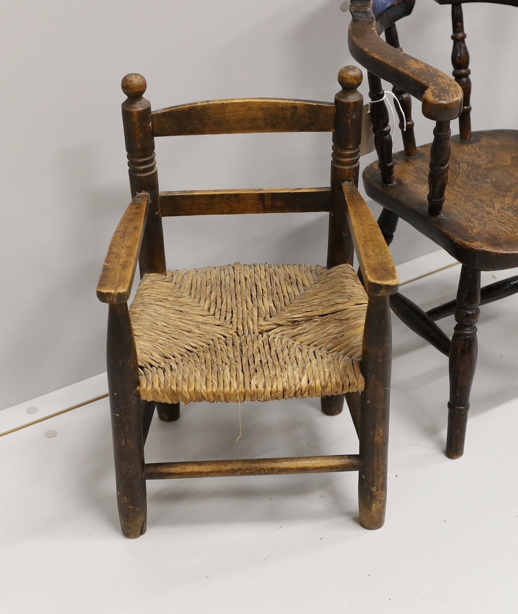 A child's Victorian elm and beech bow chair, a single chair and a rush seat chair